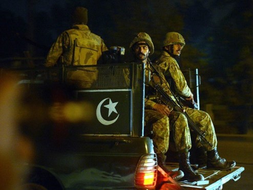 Pakistani army personnel patrol the streets following an attack by Taliban gunmen on a school in Peshawar on December 16, 2014. PHOTO: AFP