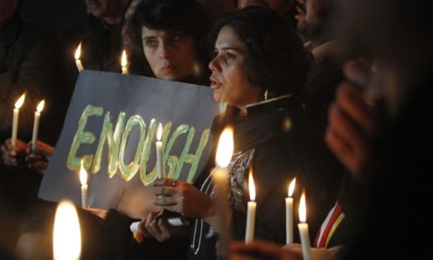 Pakistan civil society members gather for a vigil to pay tribute to the victims of the school attack in Peshawar